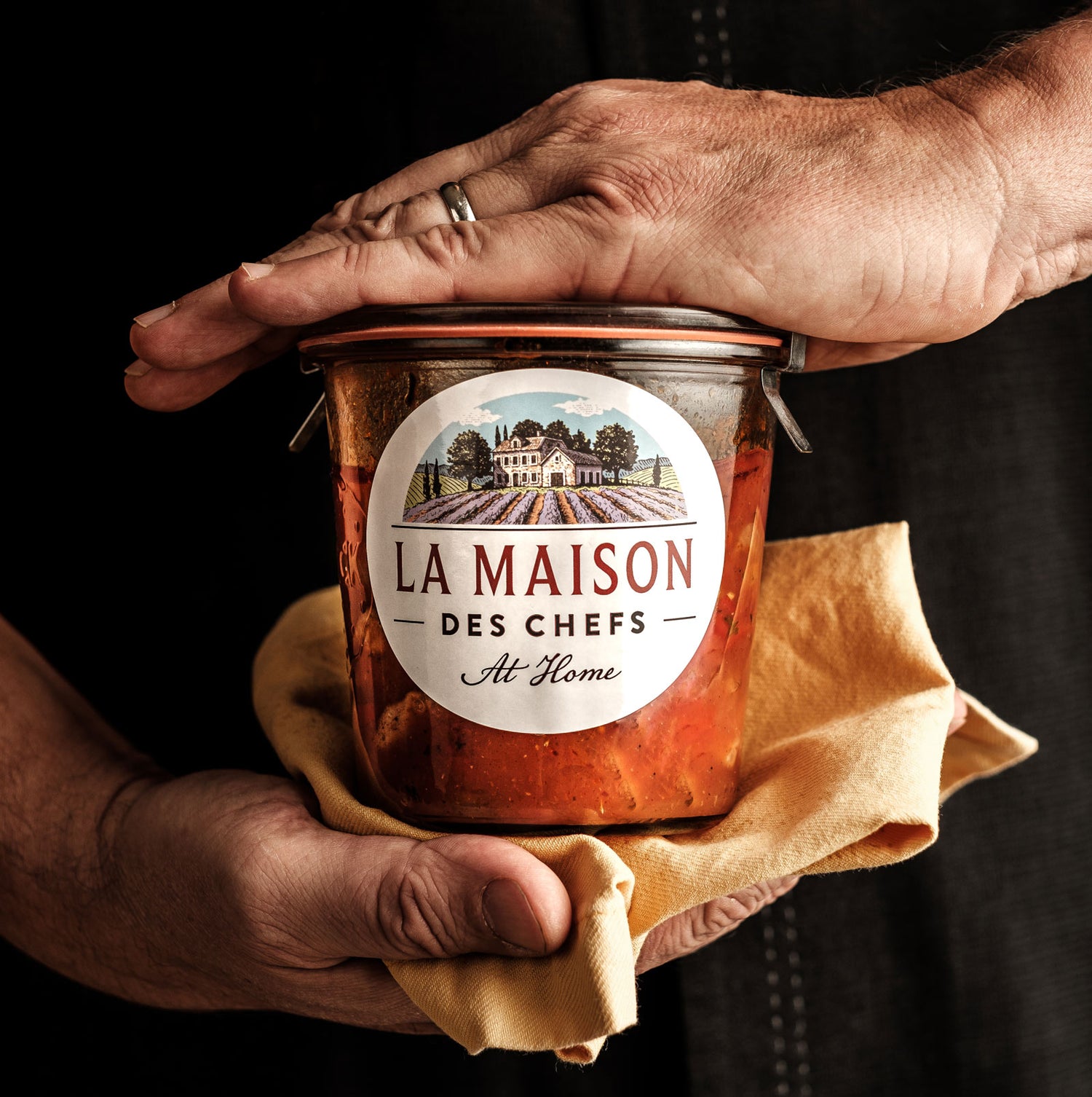 Chef hold jar of traditional French countryside recipe in hands
